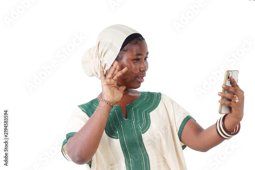African woman making a video call, hand raised near her face