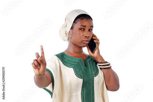 Obraz na płótnie African woman on the phone raising her index finger in a warning gesture