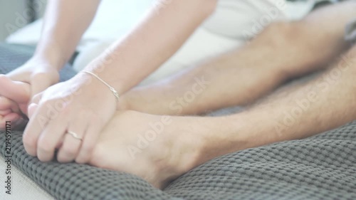 Close-up of bare feet resting on a sofa or bed at home, relaxed lifestyle and comfort concept with soft focus background