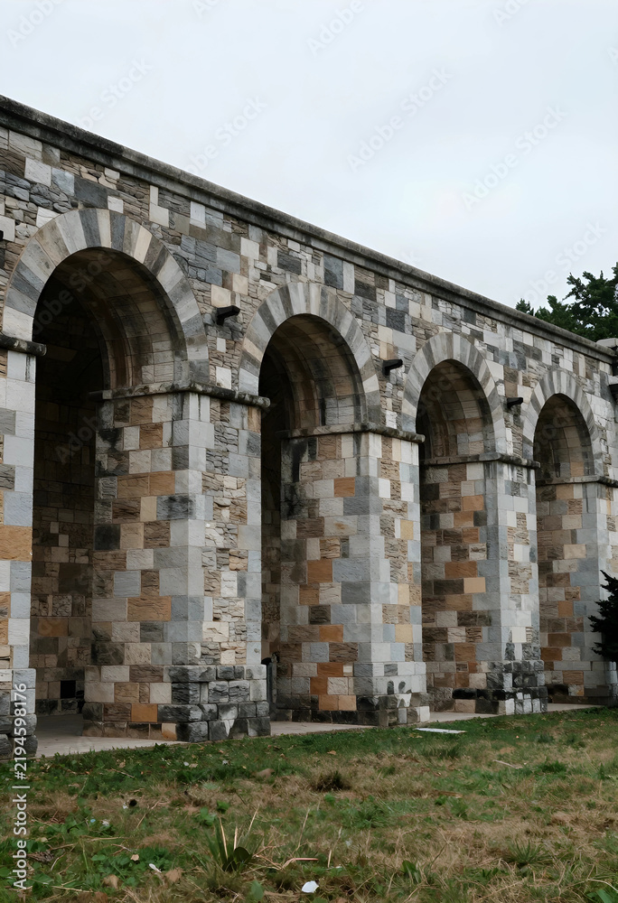 Obraz premium Heritage conservation and historical architecture, stone archway structure with masonry walls and classic design elements in a public park setting