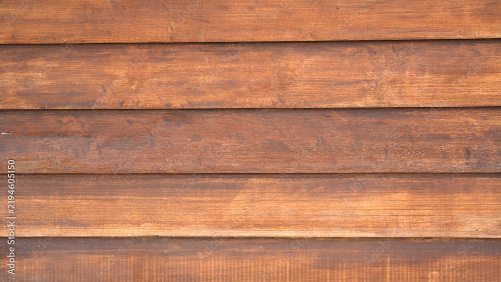 Obraz premium Horizontal lap siding style brown wooden plank background with shadow lines and rich timber texture for exterior architectural designs