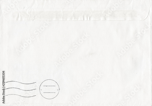 Old vintage white mail envelope with postal stamp mark and wavy cancellation lines. Crumpled aged paper texture with empty copy space background
