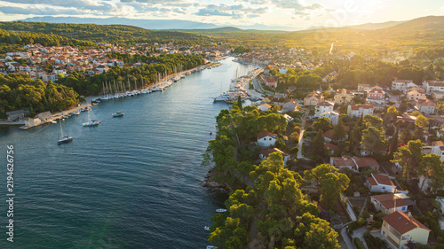 High angle drone shot displays stunning coastal landscape of Hvar Island. Panorama includes historic Stari Grad port