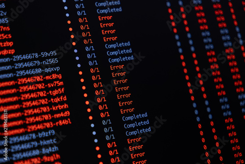 Obraz na płótnie Programming code showing a list of task statuses with many red error messages and blue completed marks on a dark screen representing software debugging or system failure