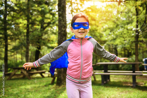 Obraz na plátně kid Superhero playing and having fun outdoor