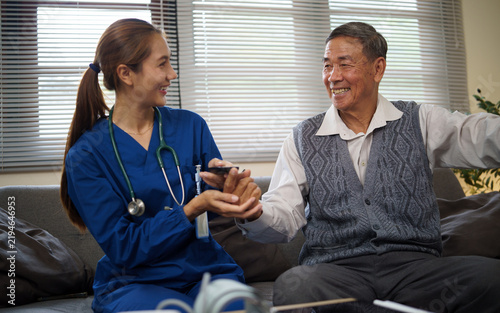 Obraz na płótnie Home care nurse helping an elderly man manage daily medication safely
