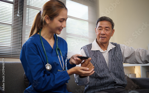 Obraz na płótnie Home care nurse helping an elderly man manage daily medication safely