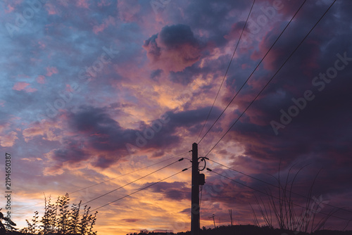 Beautiful sunset sky with a utility pole silhouette in the countryside