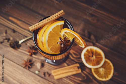 Canvastavla Mulled wine with orange and cinnamon on a wooden table