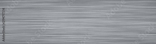 Grey brushed metal texture background with horizontal lines and silver metallic surface.