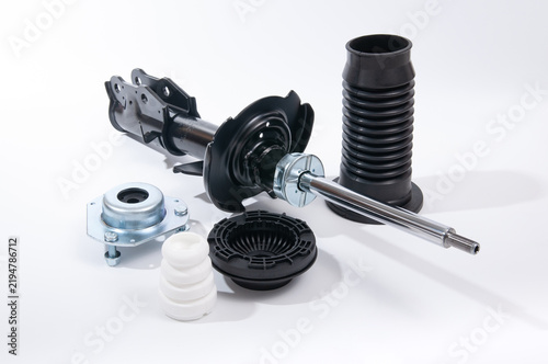 Set of new car front and rear shock absorbers with accessories.