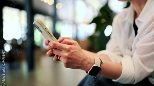 Casual close-up of a woman’s hands holding a smartphone, conveying modern communication, mobile technology, connectivity and everyday digital life in a relaxed indoor setting