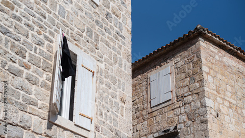 Bild auf Leinwand Traditional stone buildings in Budva, Montenegro, feature rustic masonry and whi