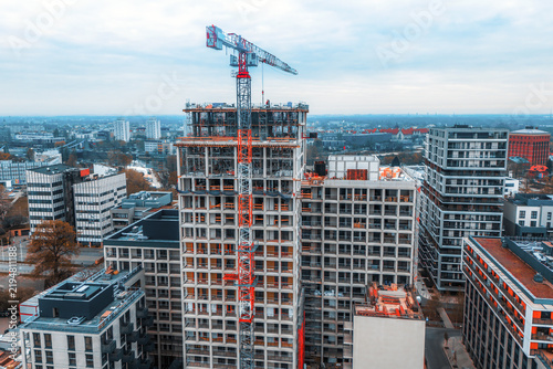 Modern building under construction with urban crane