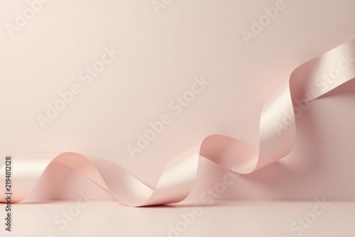 Elegant Pink Ribbon Swirling on Soft Background, a Serene and Graceful Composition for Design Inspiration