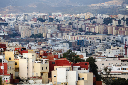 Dense cityscape of Ceuta city center with residential buildings and mountains