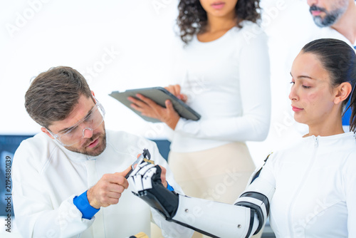 Fotografie Haptic feedback engineering in a bright lab, a researcher tilts the robotic pros