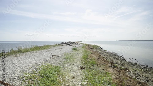 Rocks and rare plants growing on them. The gently sloping rocky shore is a popular spot for recreation and hiking. The Baltic Sea coast in Estonia in August. Hiiuma