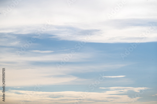 Peaceful sky background with soft white cloud layers in calm blue atmosphere filled with daylight creating serene natural mood