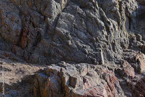 Fotografía Rugged mountain cliff face with weathered granite rock formations and natural st