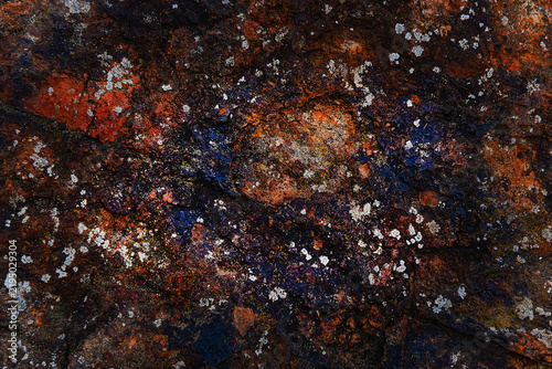 Obraz na plátne Abstract dark background featuring a rugged stone surface with vibrant rust, cop