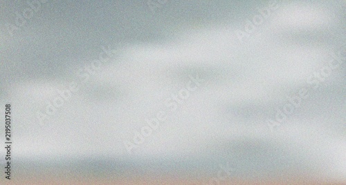 Ethereal light blue gray granular surface featuring soft, cloud like areas of gentle diffuse illumination