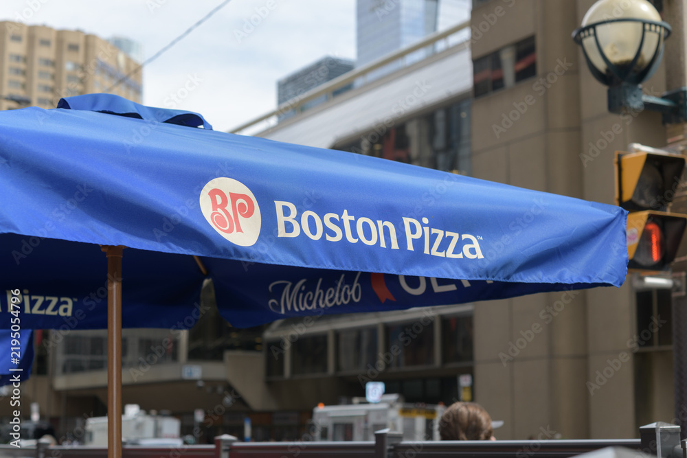 Obraz premium patio umbrella with Boston Pizza branding outside the pizza restaurant chain, located here at 250 Front St W, Toronto