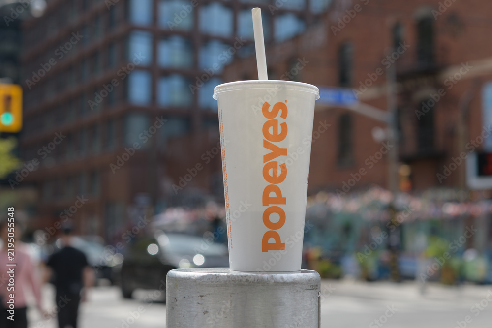 Obraz premium discarded Popeyes Louisiana Kitchen beverage cup on Queen St W, Toronto (front)