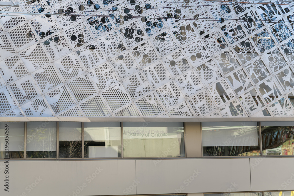 Obraz premium faint reflection of Art Gallery of Ontario sign on a window at the Rosalie Sharp Pavilion with data-mapped metal scrim designed by Tania Bortolotto, Toronto