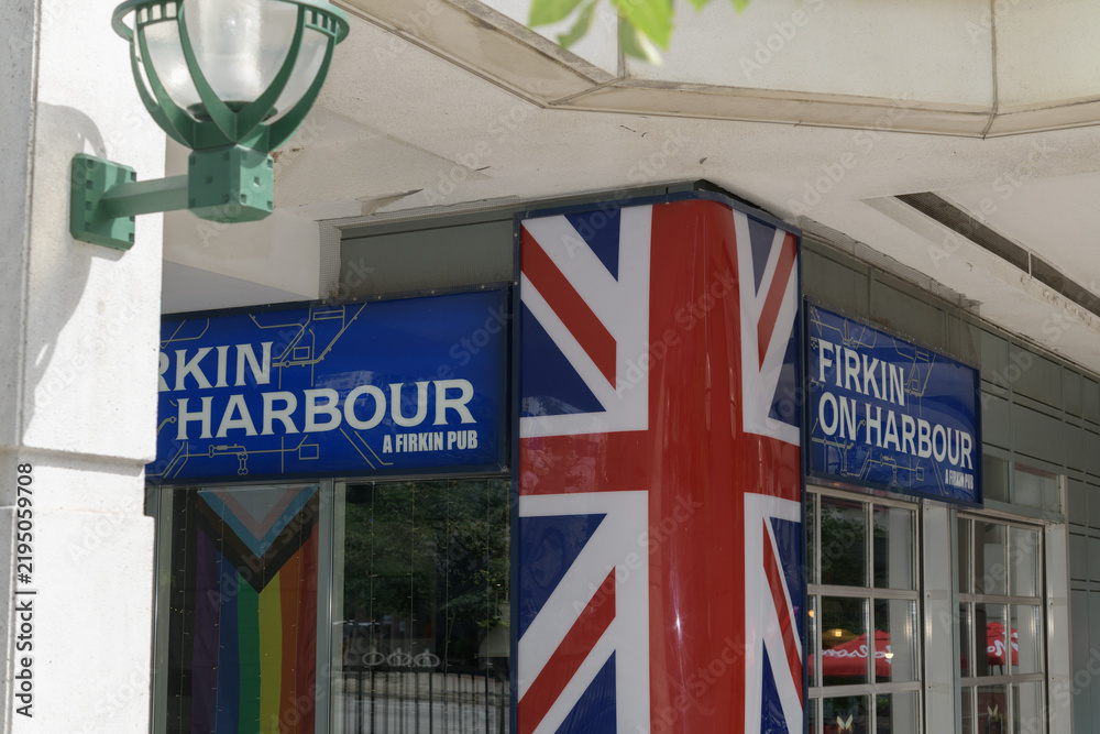 Obraz premium exterior building and sign of Firkin on Harbour, a pub chain, located here at 21 Harbour St in Shoppes of the World Trade Centre, Toronto