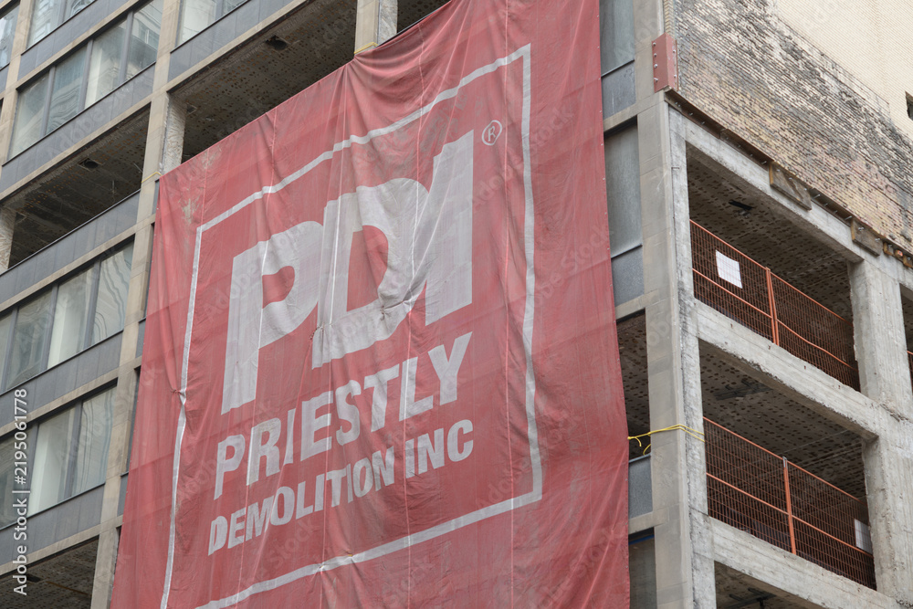 Fototapeta premium enormous PDI / Priestly Demolition Inc banner stretched over development project at 55 Yonge St, Toronto