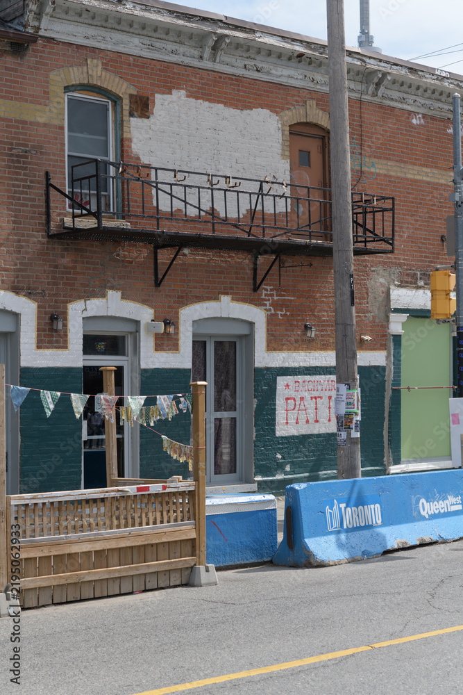 Fototapeta premium historic commercial building located at 458-460 Queen St W (former Duke of Connaught Tavern, now Drom Taberna), Toronto - patio on Augusta Av