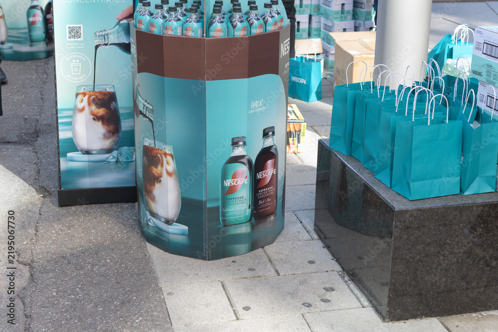 Fototapeta premium Nescafé novelty table-bins with full-size bottles of espresso coffee concentrate on John St, Toronto