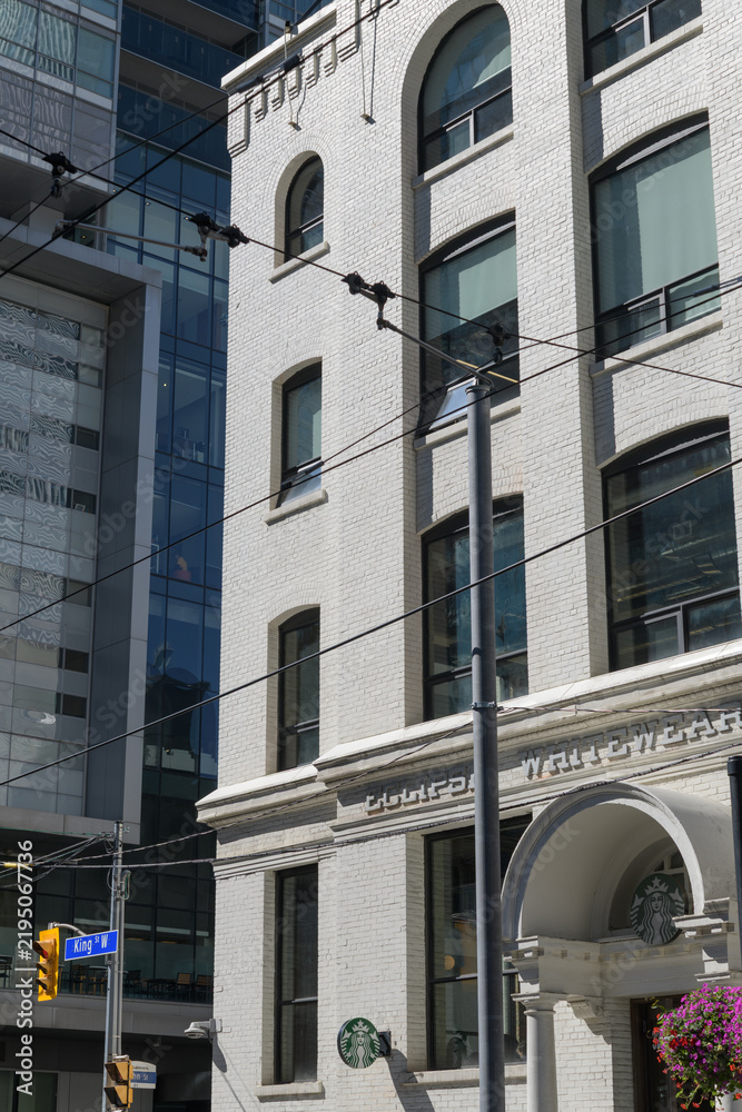 Obraz premium exterior building facade and sign of historic Eclipse Whitewear Company factory located at 322 King St W (site of a Starbucks Coffee shop), Toronto