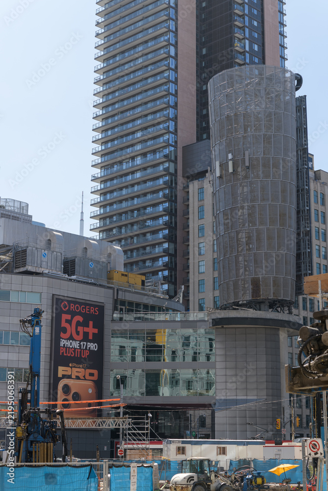 Obraz premium wall mounted billboard with Rogers Communications promotion of 5G+ and iPhone at 33 Dundas St E, Toronto (near southeast corner of Sankofa Square)