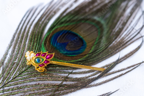 Close up of beautiful peacock feather and golden flute as symbol of Hindu god Lord Krishna.