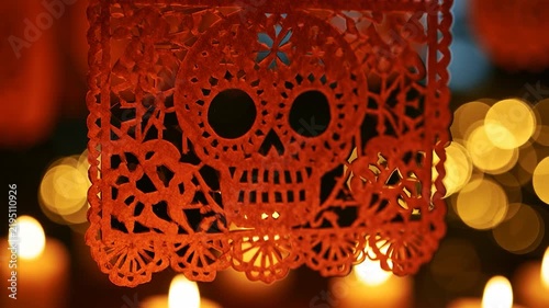 Deep Orange Papel Picado Skull Decoration with Warm Candle Bokeh