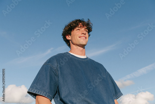 Happy Young Man Smiling Under Blue Sky