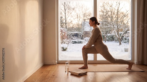 Adult Doing Morning Workout By Snowy Window For Winter Fitness, Energy And Healthy Daily Routine