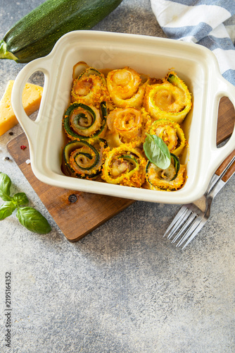 Baked zucchini rolls breadcrumb filled with a bacon and cheesy on a stone surface. Vegetarian appetizer. Celebration of important event. Copy space.