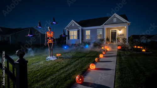 Spooky Halloween Decorations on a Suburban House at Night with Glowing Jack-o'-Lanterns, Skeleton, and Fog