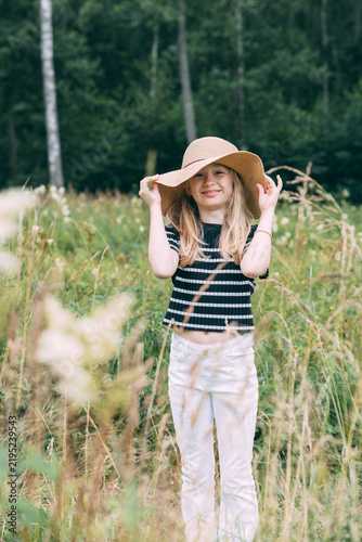 Girl with hat in field