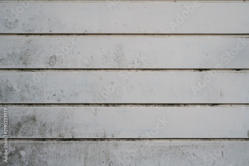 White painted metal texture with horizontal panels and weathered dirty surface