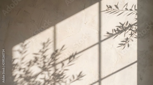 Minimalist background featuring a beige limewash textured plaster wall with elegant geometric window pane shadow play and copy space for design.