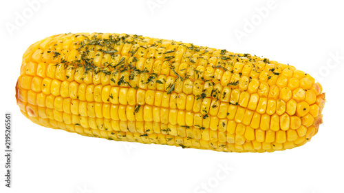 Fotografie Isolated cooked corn on the cob seasoned with green herbs ready to eat for healt