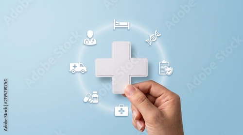 Healthcare concept with a hand holding a plus sign surrounded by medical icons. A circle of icons like doctor, DNA, hospital bed, ambulance.