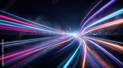 Abstract light trails showing the speed of light on a dark road