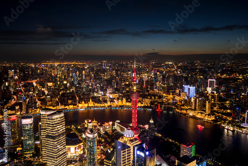 Photography Aerial night view of majestic skyscrapers in Shanghai CBD and along the Huangpu River