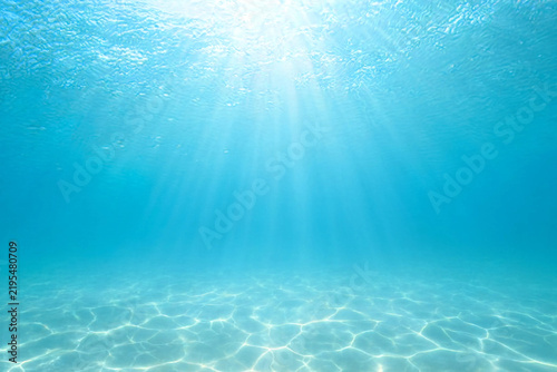 Underwater Blue Ocean Background with Sun Rays, Clear Water Surface, Soft Light Reflections, Rippled Texture and Abstract Aquatic Nature Scene for Summer Design