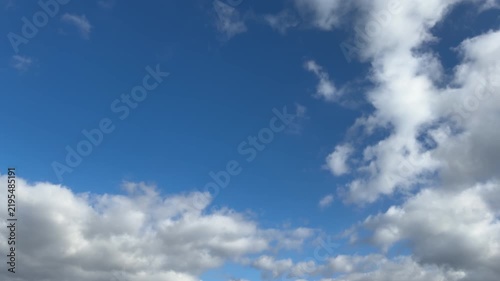 Drifting White Clouds Framing Deep Blue Sky with Wide Copy Space
